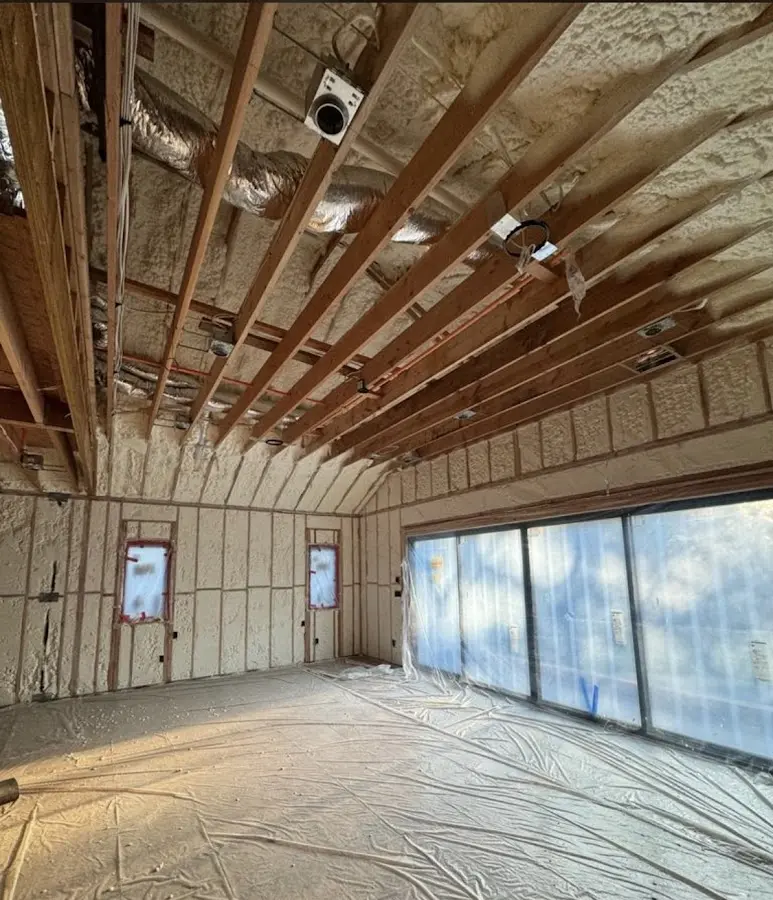 Interior walls and ceiling insulated with spray foam during new construction in Newton